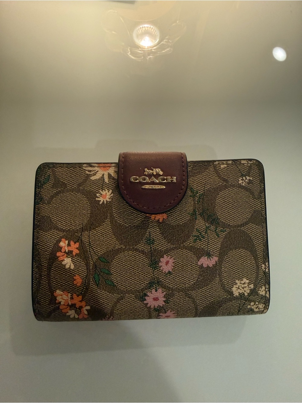 COACH Brown Signature Floral Compact Wallet with Gold Logo